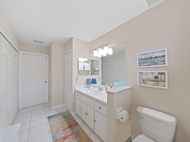 bathroom with vanity, tile patterned flooring, and toilet