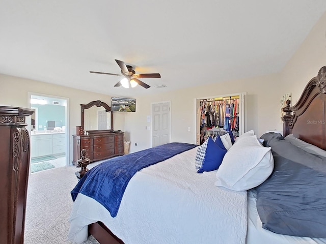 bedroom featuring ensuite bath, a closet, ceiling fan, and a spacious closet