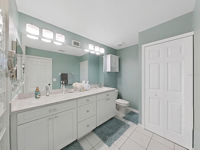 bathroom featuring tile patterned floors, vanity, and toilet