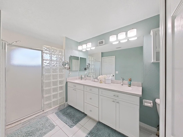 bathroom featuring vanity, tile patterned floors, and walk in shower