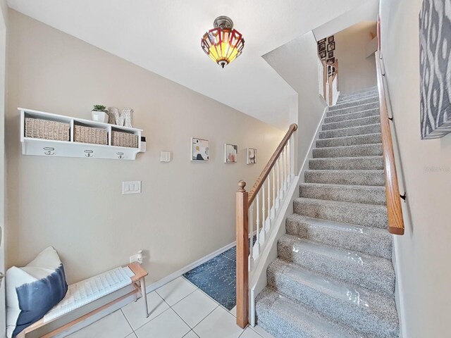 stairway featuring tile patterned flooring