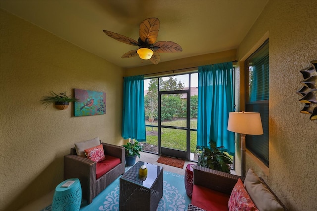 sunroom featuring ceiling fan