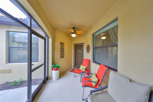 sunroom / solarium featuring ceiling fan