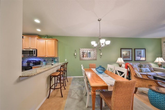 dining space with an inviting chandelier