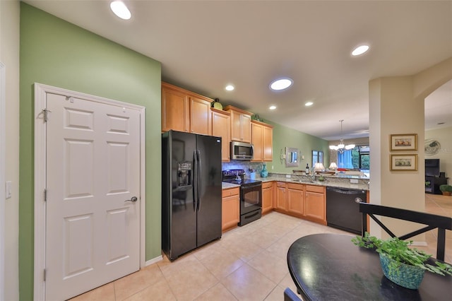 kitchen featuring light tile patterned flooring, black appliances, hanging light fixtures, a notable chandelier, and backsplash