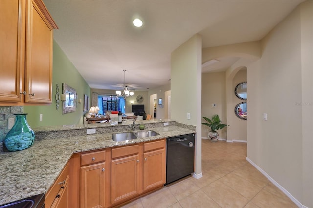 kitchen featuring light tile patterned flooring, sink, black dishwasher, ceiling fan, and light stone countertops