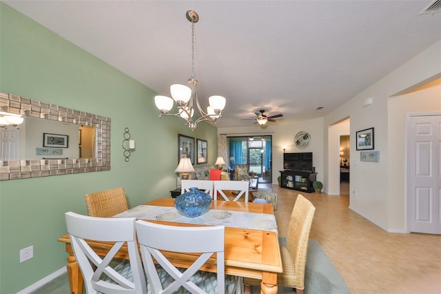 dining area with ceiling fan with notable chandelier and light tile patterned floors