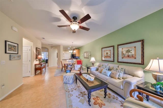 living room with ceiling fan and light tile patterned floors