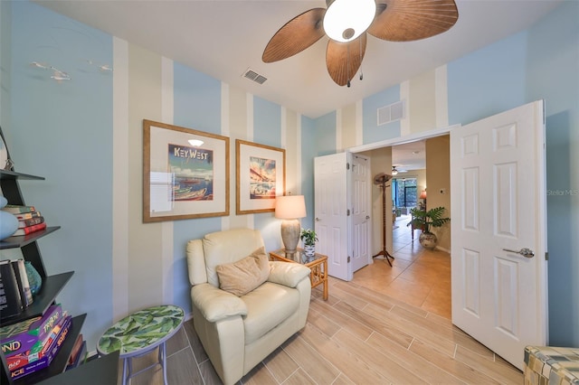 sitting room with ceiling fan