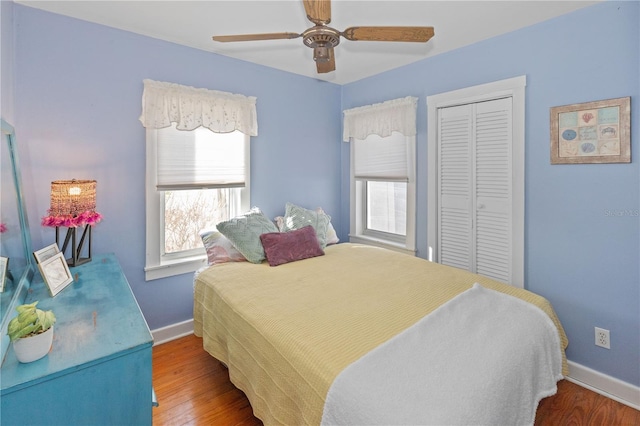 bedroom featuring wood-type flooring, a closet, and ceiling fan