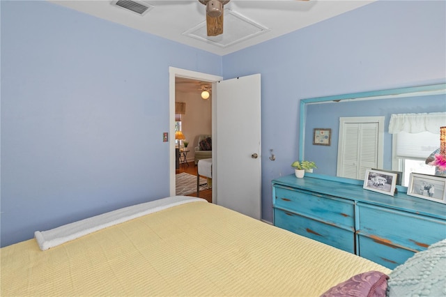 bedroom with ceiling fan and a closet