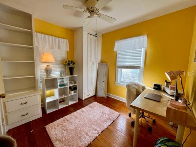 office area with dark hardwood / wood-style floors and ceiling fan