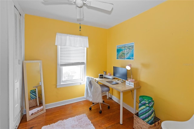 office with ceiling fan and light hardwood / wood-style flooring