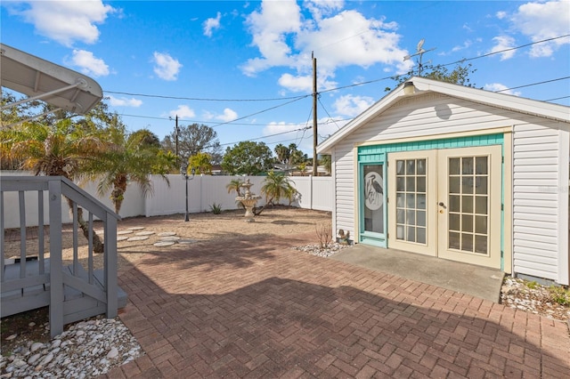 view of patio featuring an outbuilding and french doors