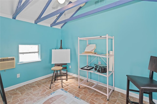 office area with a wall unit AC and lofted ceiling with beams