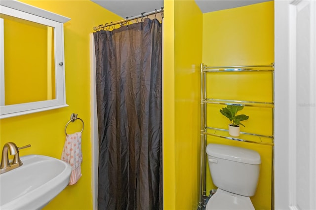 bathroom with sink, toilet, and walk in shower