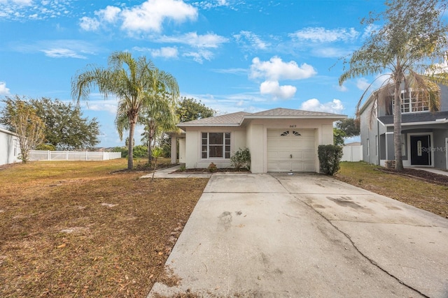 ranch-style home with a garage and a front yard