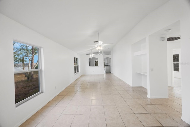 unfurnished living room featuring vaulted ceiling, light tile patterned floors, and ceiling fan