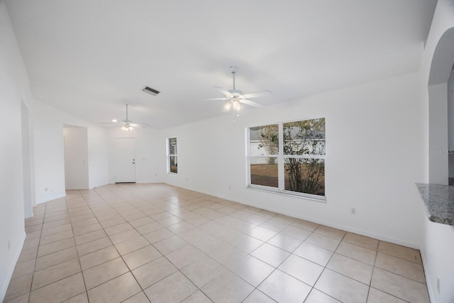 empty room featuring light tile patterned flooring and ceiling fan