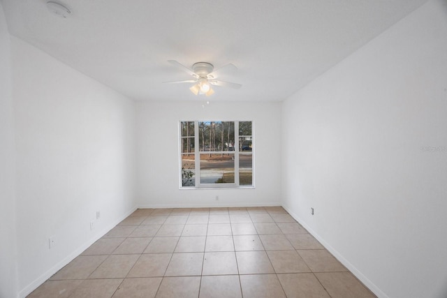 empty room featuring light tile patterned flooring and ceiling fan