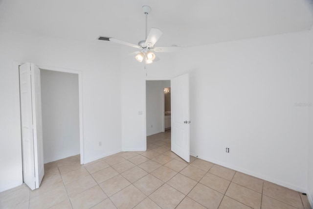 unfurnished room with ceiling fan and light tile patterned floors