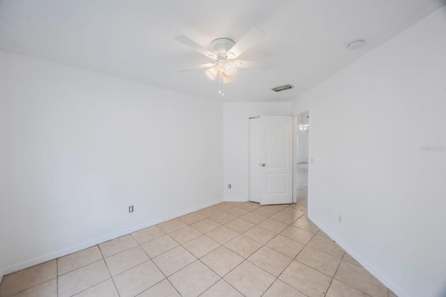 tiled spare room with ceiling fan