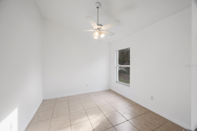 tiled spare room with ceiling fan