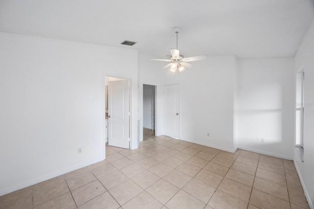 tiled empty room featuring lofted ceiling and ceiling fan