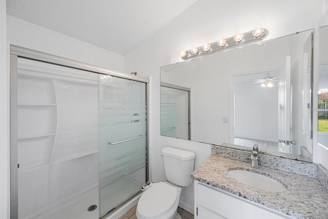 bathroom featuring an enclosed shower, vanity, vaulted ceiling, and toilet