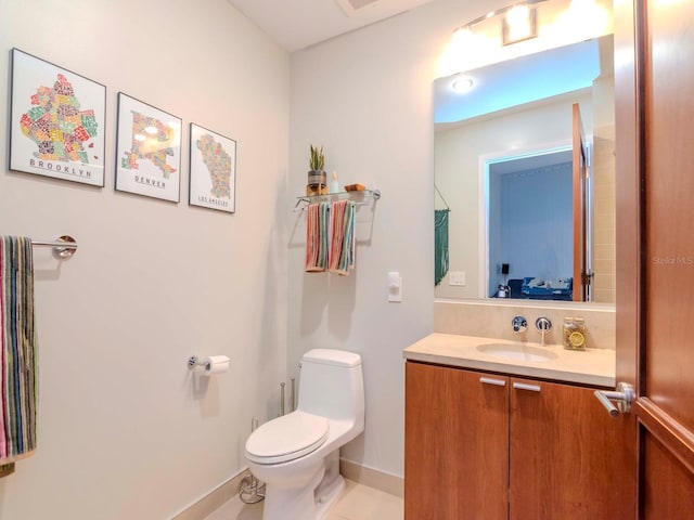 bathroom featuring vanity and toilet