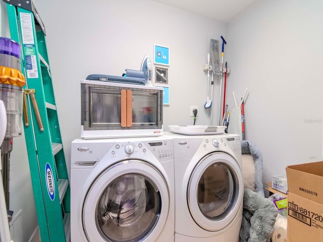 clothes washing area featuring washer and dryer