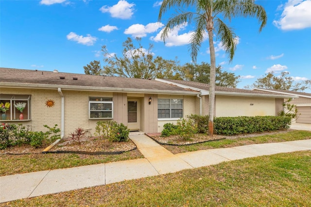 ranch-style home with a front lawn