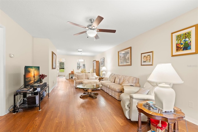 living room featuring hardwood / wood-style flooring and ceiling fan