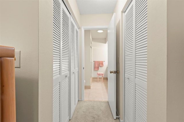 hallway featuring light tile patterned flooring