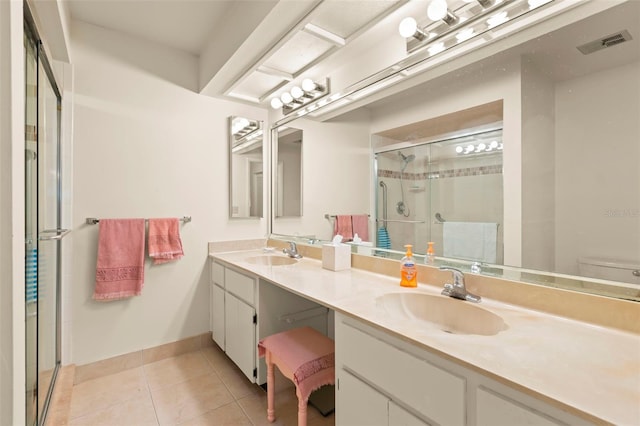 bathroom with vanity, toilet, tile patterned floors, and walk in shower