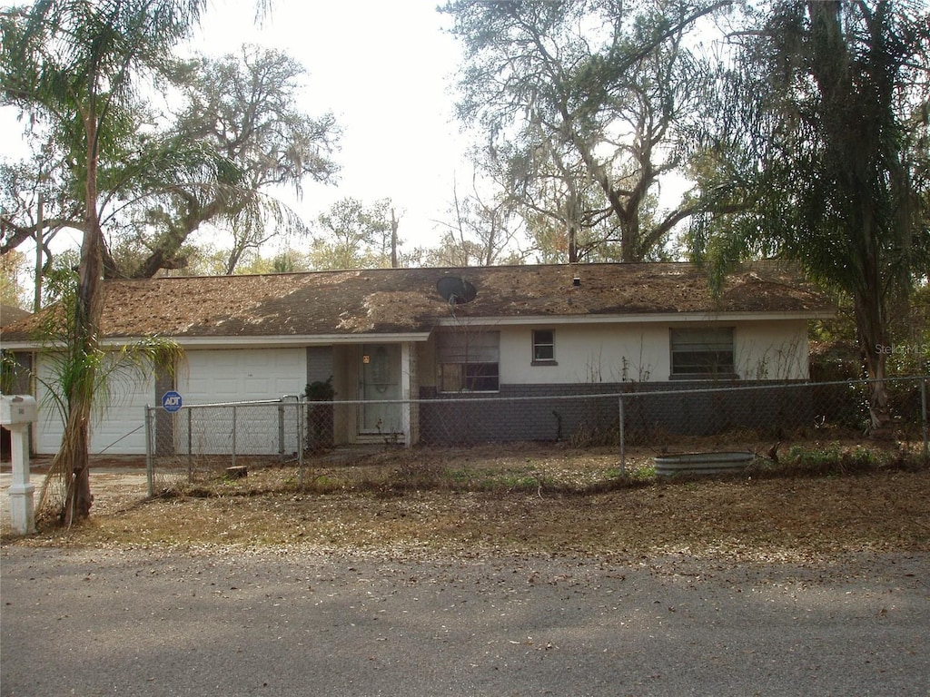 ranch-style home featuring a garage