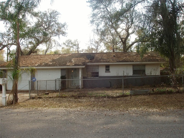 ranch-style home featuring a garage