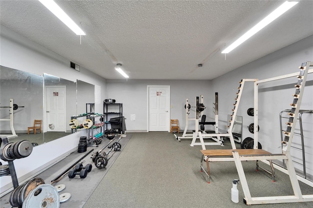 gym with a textured ceiling