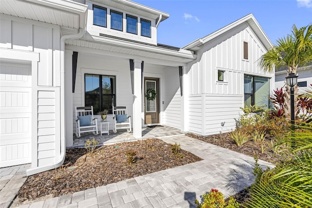 view of exterior entry featuring a porch