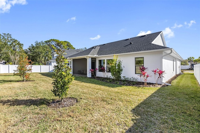 rear view of property featuring a yard