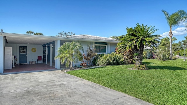 view of front of home with a front lawn and a carport