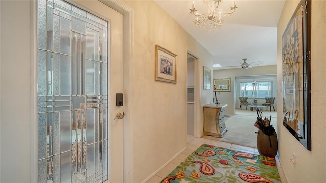 corridor featuring light tile patterned floors and a notable chandelier