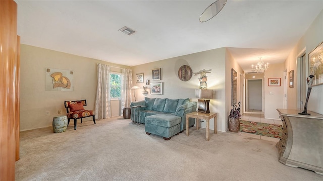 carpeted living room with a chandelier