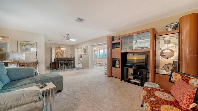 living room featuring light colored carpet and ceiling fan