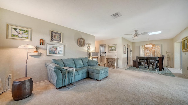 living room featuring light carpet and ceiling fan