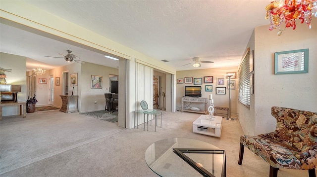 living room with light carpet, a textured ceiling, and ceiling fan