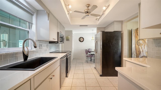 kitchen with stainless steel appliances, sink, and white cabinets