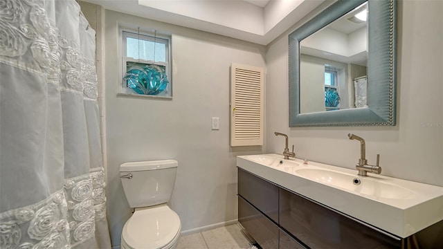 bathroom with vanity, tile patterned flooring, and toilet