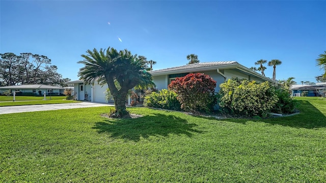 view of front of home with a garage and a front lawn