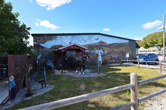 back of property featuring an outbuilding and a yard